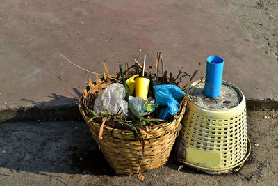 High angle view of bottles in basket on street