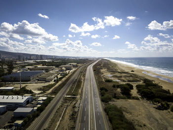 High angle view of road by sea against sky