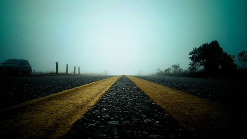 Road by landscape against clear sky