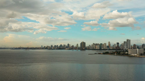 Scenic view of sea by buildings against sky