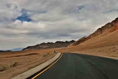 Road amidst landscape against sky