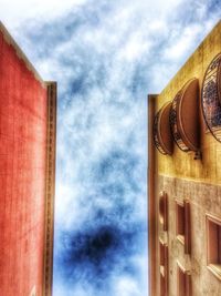 Low angle view of building against cloudy sky