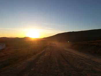 Scenic view of road against sky during sunset