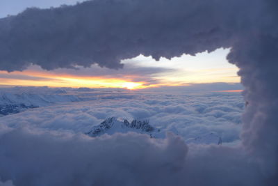 Scenic view of snow landscape against sky during sunset
