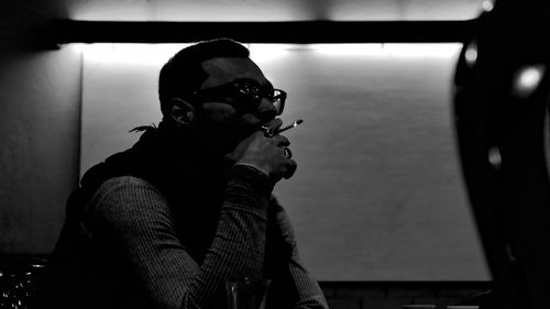 Portrait of man smoking on sunglasses