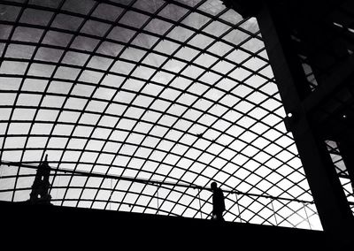 Low angle view of silhouette built structure against sky