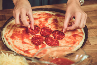 Close-up of hand holding pizza