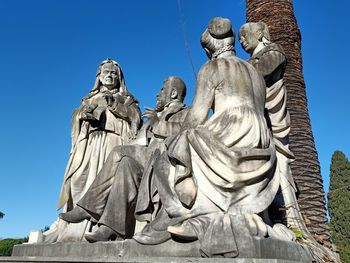 Low angle view of statue against clear blue sky