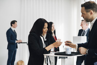 Female and male entrepreneur discussing at workplace