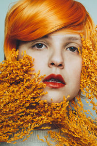 Close-up portrait of woman with orange hair