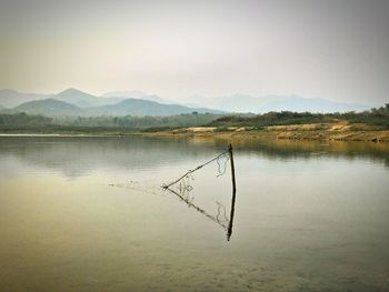 Scenic view of calm lake against mountain range