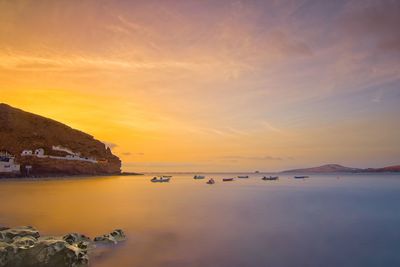 Scenic view of sea against romantic sky at sunset