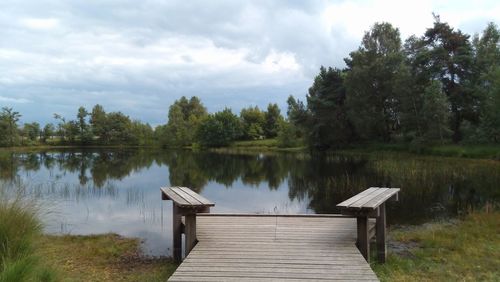 Pier over lake against sky