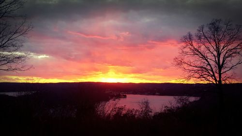 Scenic view of lake against romantic sky at sunset