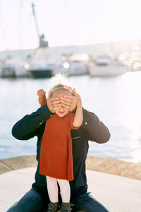 Playful father with daughter at harbor