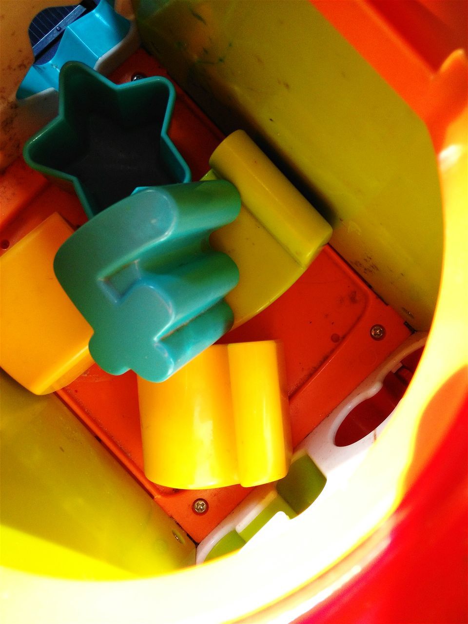 indoors, multi colored, still life, high angle view, yellow, close-up, colorful, table, childhood, creativity, toy, art and craft, no people, plastic, red, art, green color, circle, variation, orange color