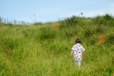 Rear view of woman on field