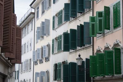 Open blinds of shade of green in a row