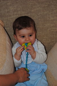 Portrait of cute baby boy on bed