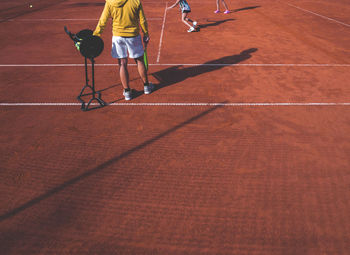 People at tennis clay court