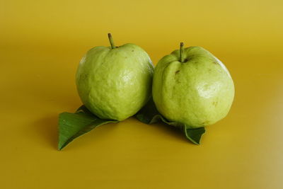 Close-up of apples against green background