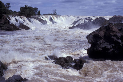 Scenic view of rocks in sea against sky