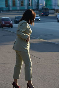 Full length of man standing on road in city