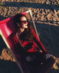 Portrait of smiling young woman sitting outdoors