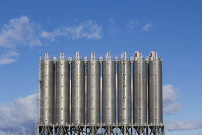 Smoke stacks against blue sky