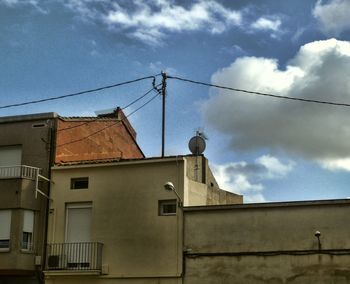 Low angle view of building against cloudy sky