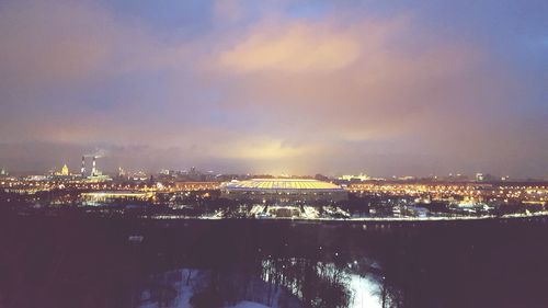 Illuminated cityscape against sky at night