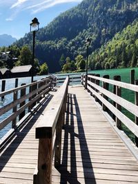 Wooden bridge against trees and mountains