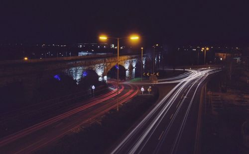 Light trails on road in city at night