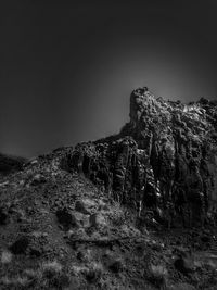 Rock formations on land against clear sky