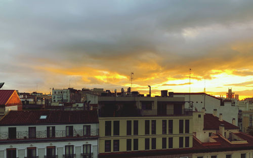 Buildings against sky at sunset