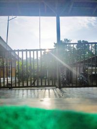 Sunlight streaming through glass window against sky on sunny day