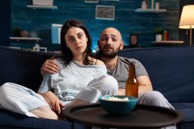 Young couple sitting on sofa