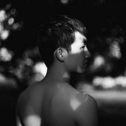 Close-up portrait of shirtless young man