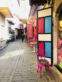 Rear view of woman sitting on street