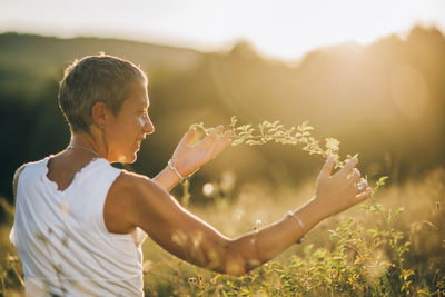 Communion with nature. peaceful woman enjoying the tactile experience of touching plants