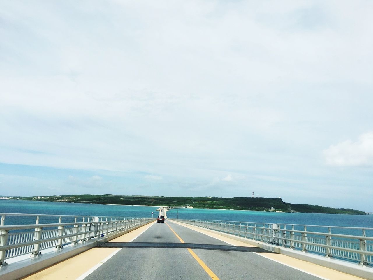 SCENIC VIEW OF ROAD BY SEA AGAINST SKY