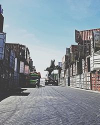 Street amidst buildings against sky in city