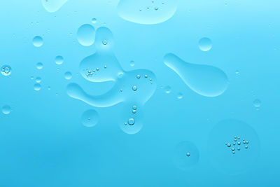 Close-up of bubbles against blue background