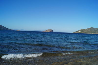 Scenic view of sea against clear blue sky