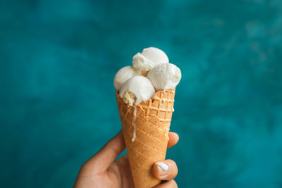 Close-up of hand holding ice cream cone