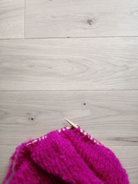 Close-up of purple flower on hardwood floor