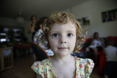 Close-up portrait of cute girl at home