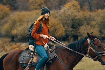 Young woman riding horse