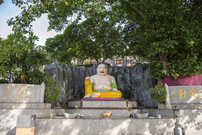 Statue against trees