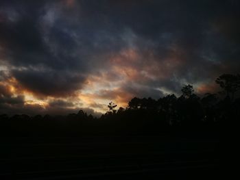 Silhouette of landscape against cloudy sky